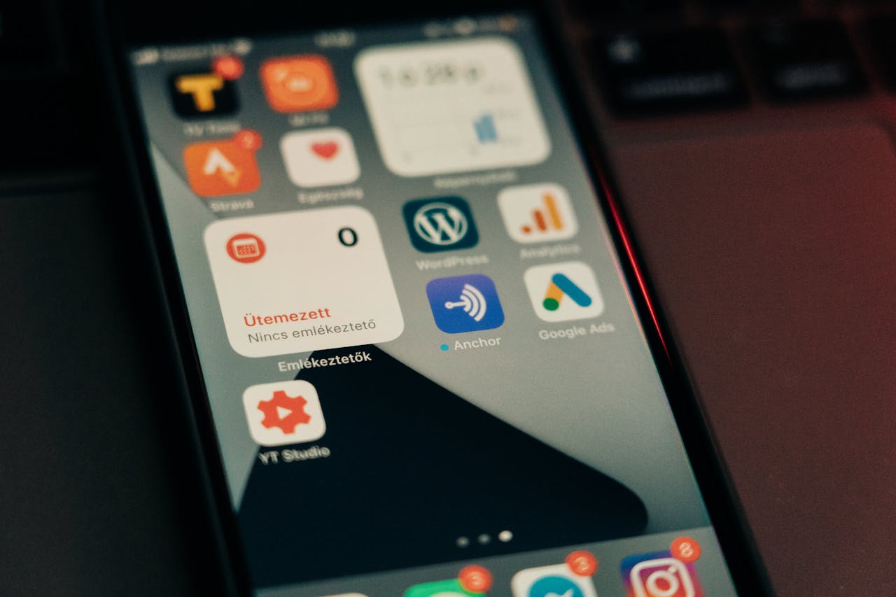 programs-03 Close-up view of smartphone screen featuring various app icons and notifications.